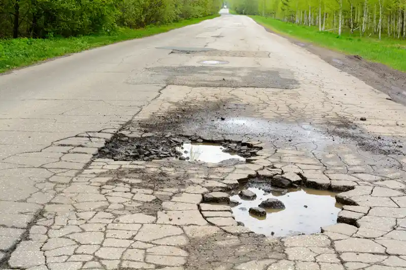 Potholes in asphalt roadway